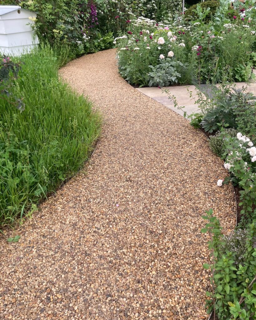 Gravel pathway installed along house for drainage and landscaping